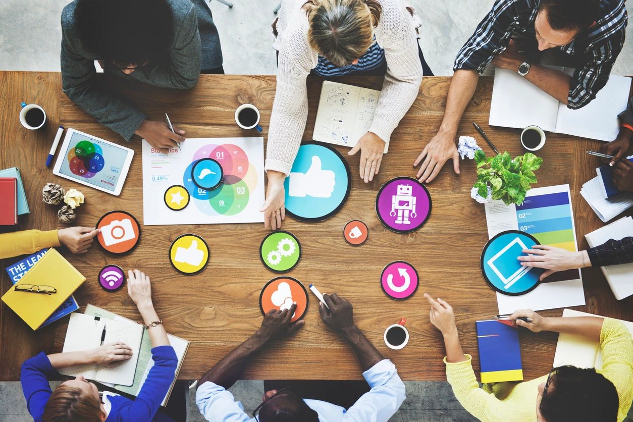 image of a group sitting around a table connecting together