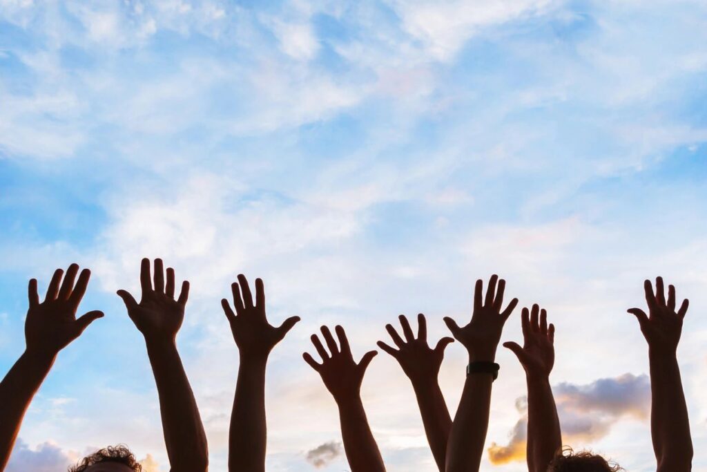 Image with people with raised hands