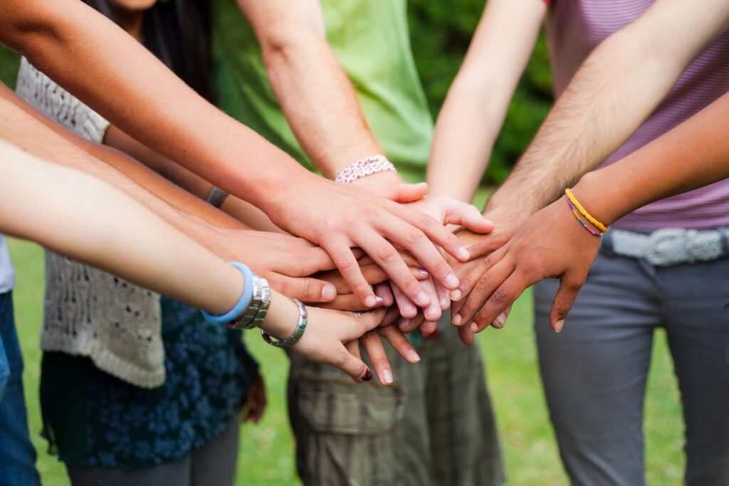 member benefits - people putting hands in a circle together