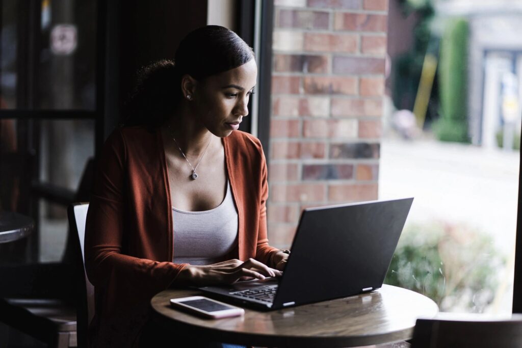 person sat at table on laptop