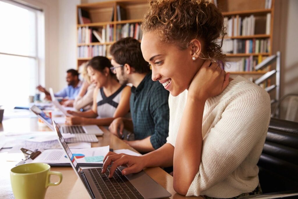 people sat using computers and chatting